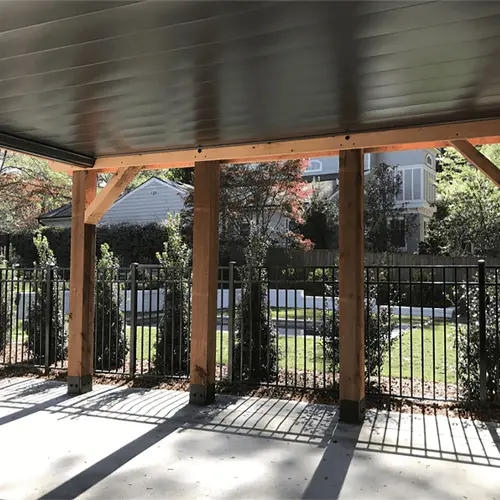 Wood post carport over a concrete drive